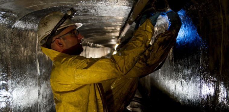 kNHT0EncSPq8u9x6PRbu_Workers apply carbon fiber mats soaked in epoxy resin to stabilize the utility tunnels that crosscross under the UA campus.jpg